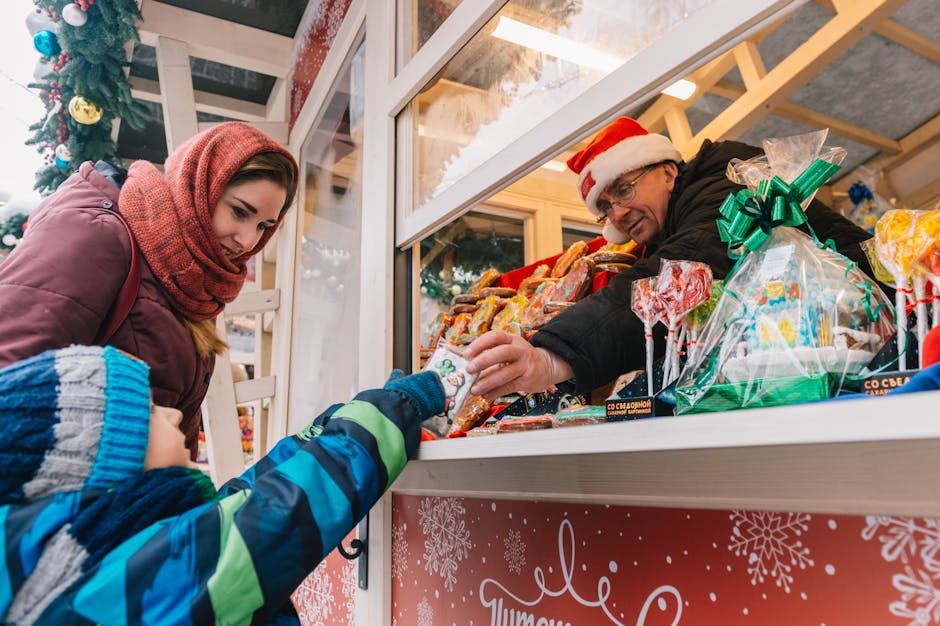 A festive scene of a mother and child selecting sweets from a Christmas market stall.